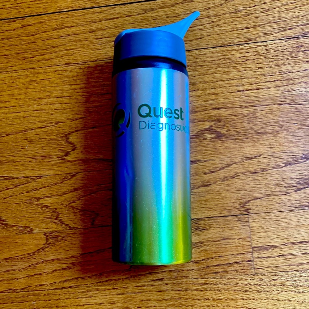 Quest Diagnostics water bottle. Silver to green ombré. A couple of small dents.